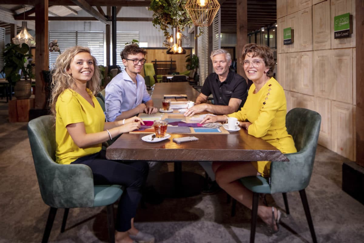 4 mensen aan een grote tafel